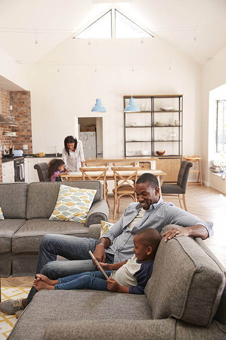 Buy or Rent A family relaxing, who found the pros to buying their home outweighed renting